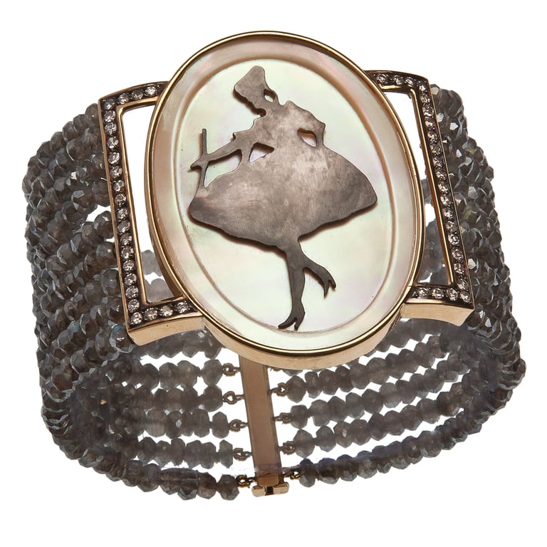 Ornate cameo cuff bracelet with silhouette of dancing figure on scale-textured dark metal band