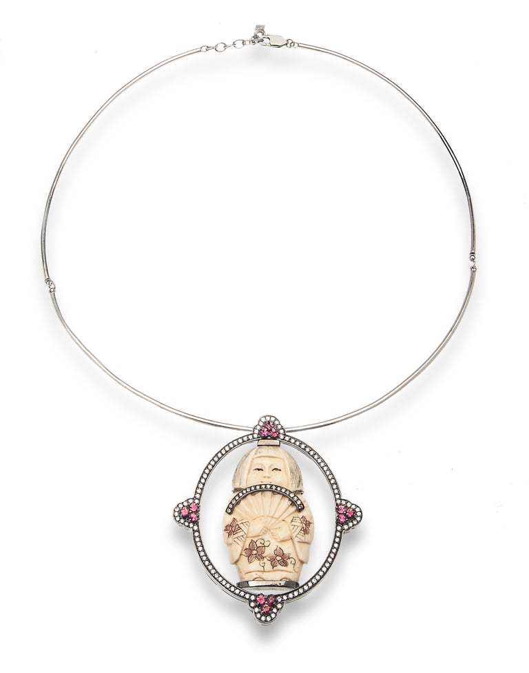 Silver wire collar necklace with ornate cameo pendant featuring carved face and pink gemstone accents