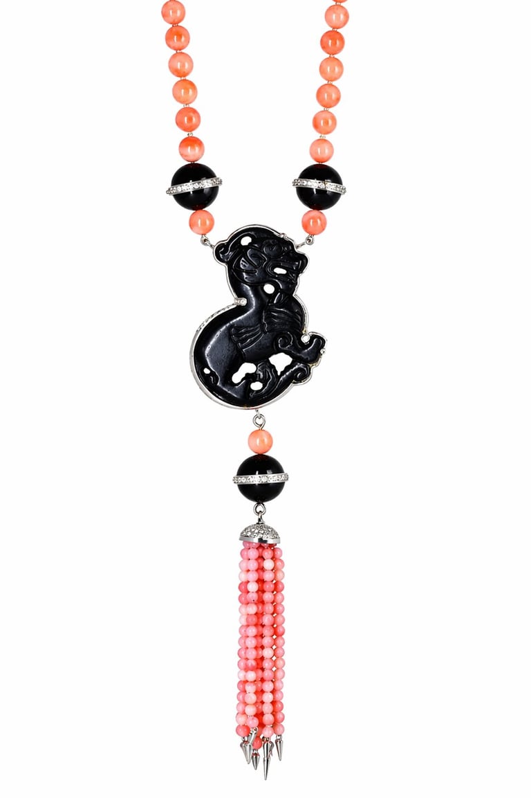 Ornate pendant necklace with black carved dragon charm, coral beads, striped black and white accents, and pink beaded tassel pendant