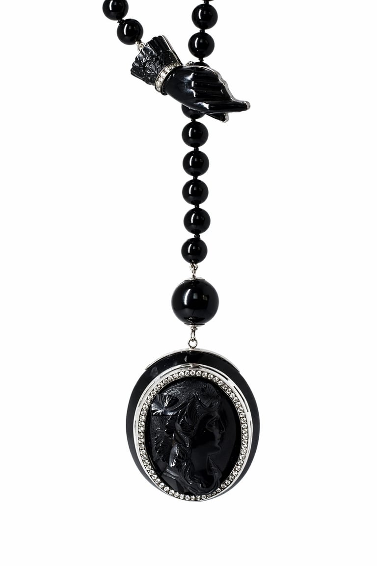 Black beaded necklace with raven pendant and oval cameo locket featuring rhinestone border